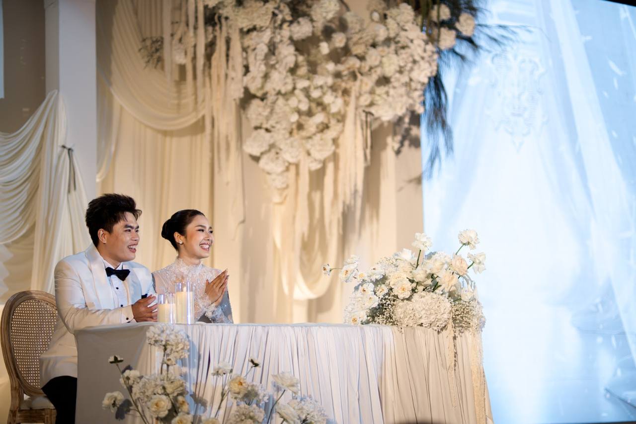 Sweet Blossom Wedding Planner white floral stage sweetheart table with couple