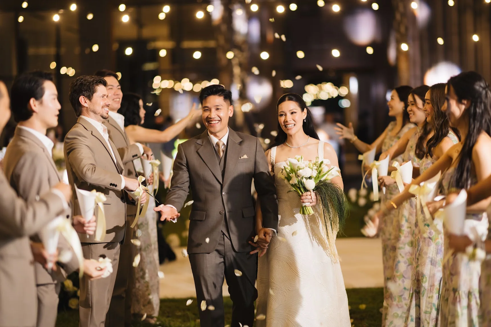 Couple entering the reception with friends at the Annie & Louis celebration in Bangkok