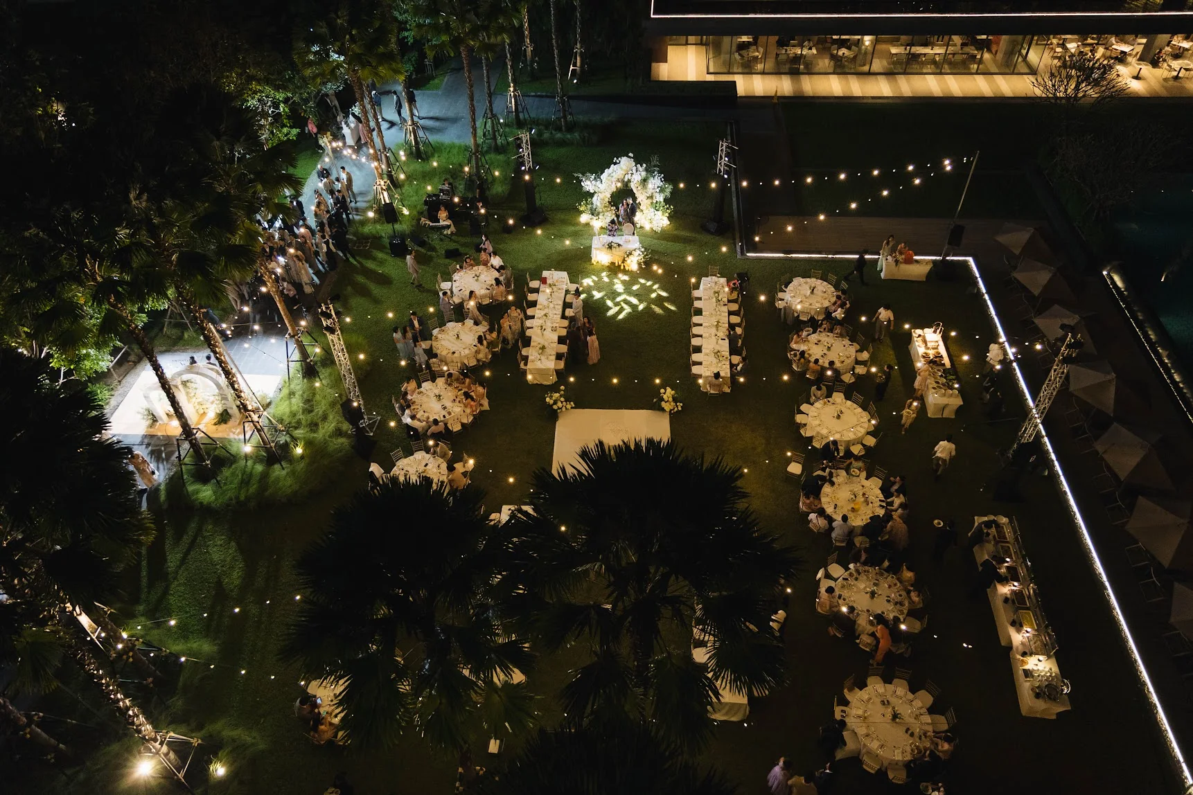 Aerial view of the candlelit lawn reception at the Annie & Louis celebration in Bangkok