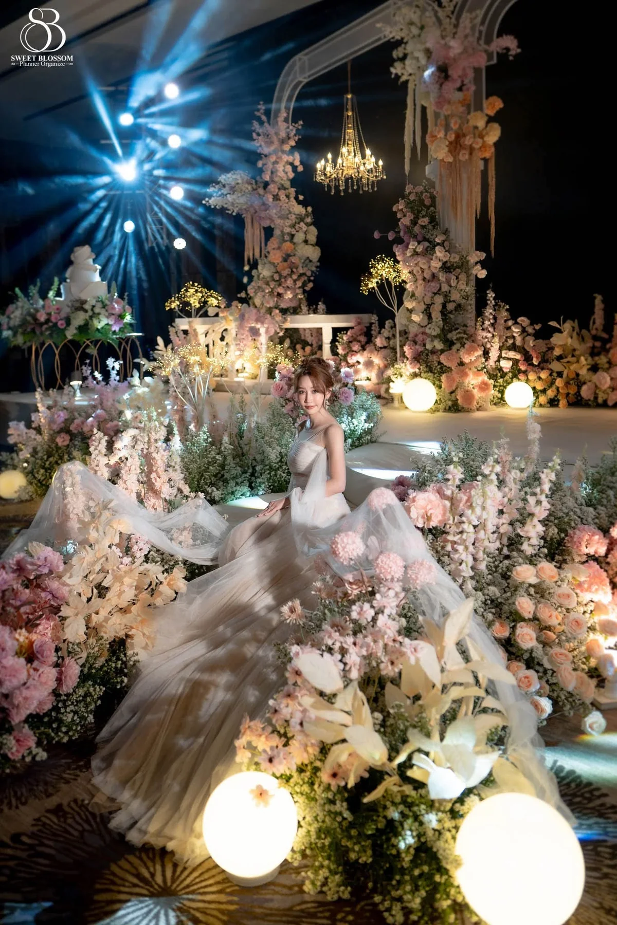 Bride walking through the flower-lined aisle at the Orm & Fuse celebration in Bangkok