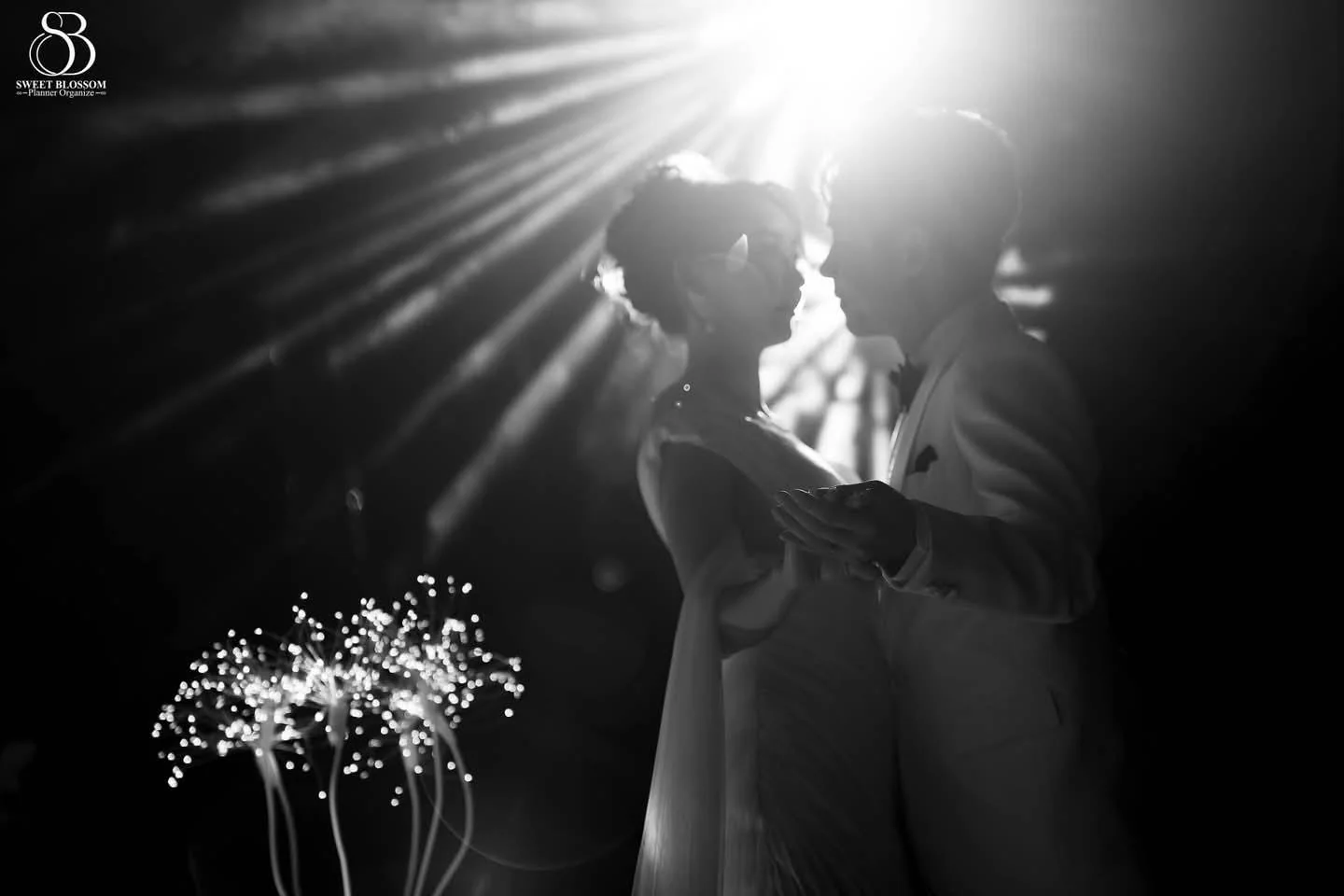 Black-and-white portrait of the couple under stage lighting at the Orm & Fuse celebration in Bangkok