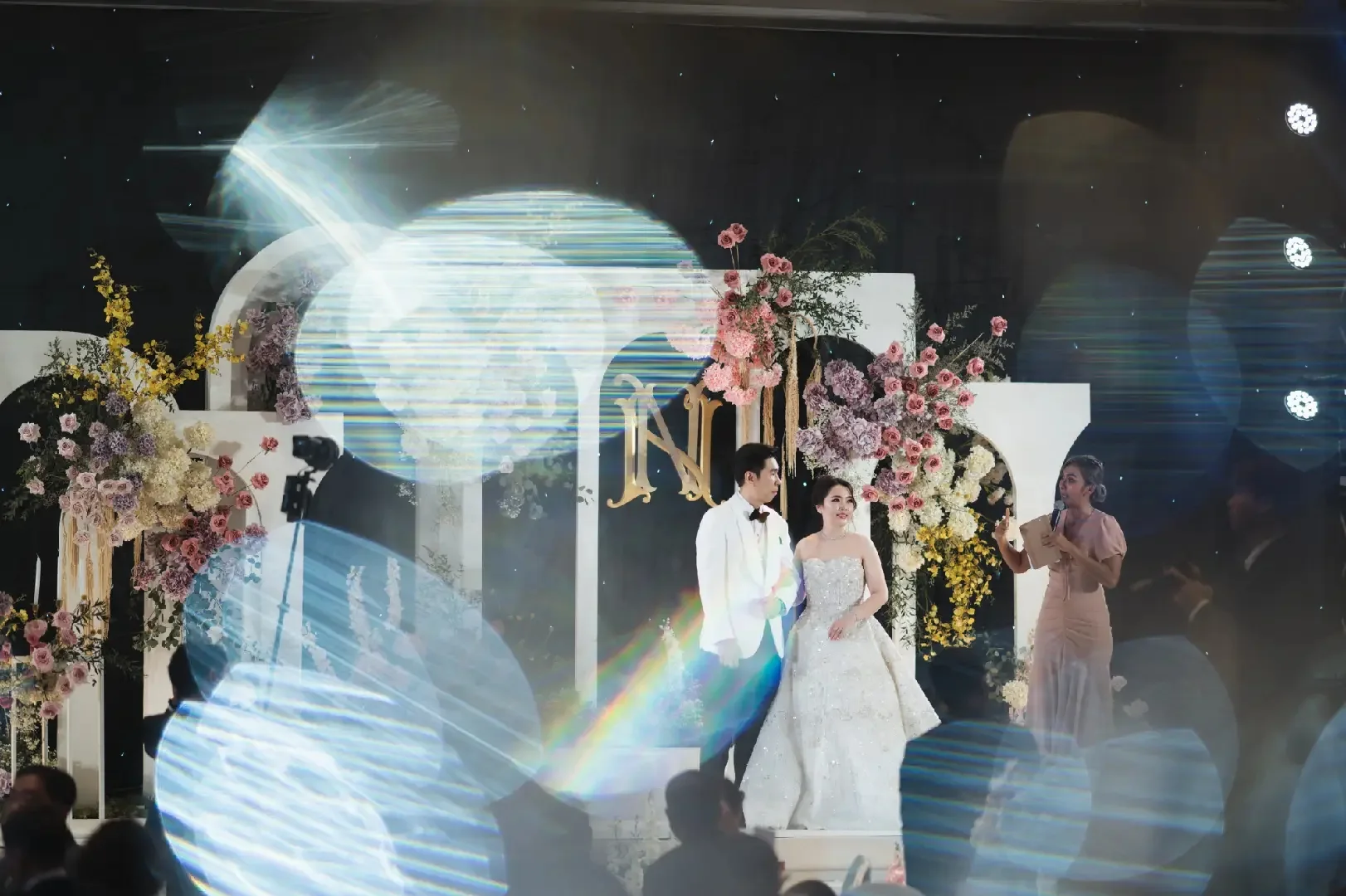 Couple dancing beneath the ballroom projection at the Jum & Jai celebration in Chonburi