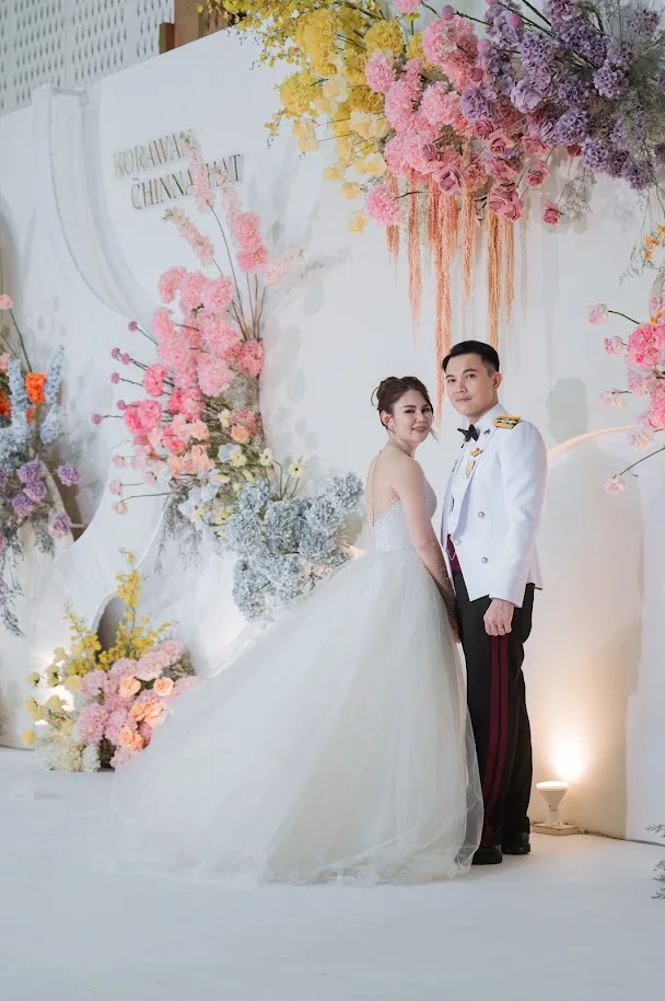 Couple portrait at the pastel wedding stage at the Koko & Raam celebration in Chonburi
