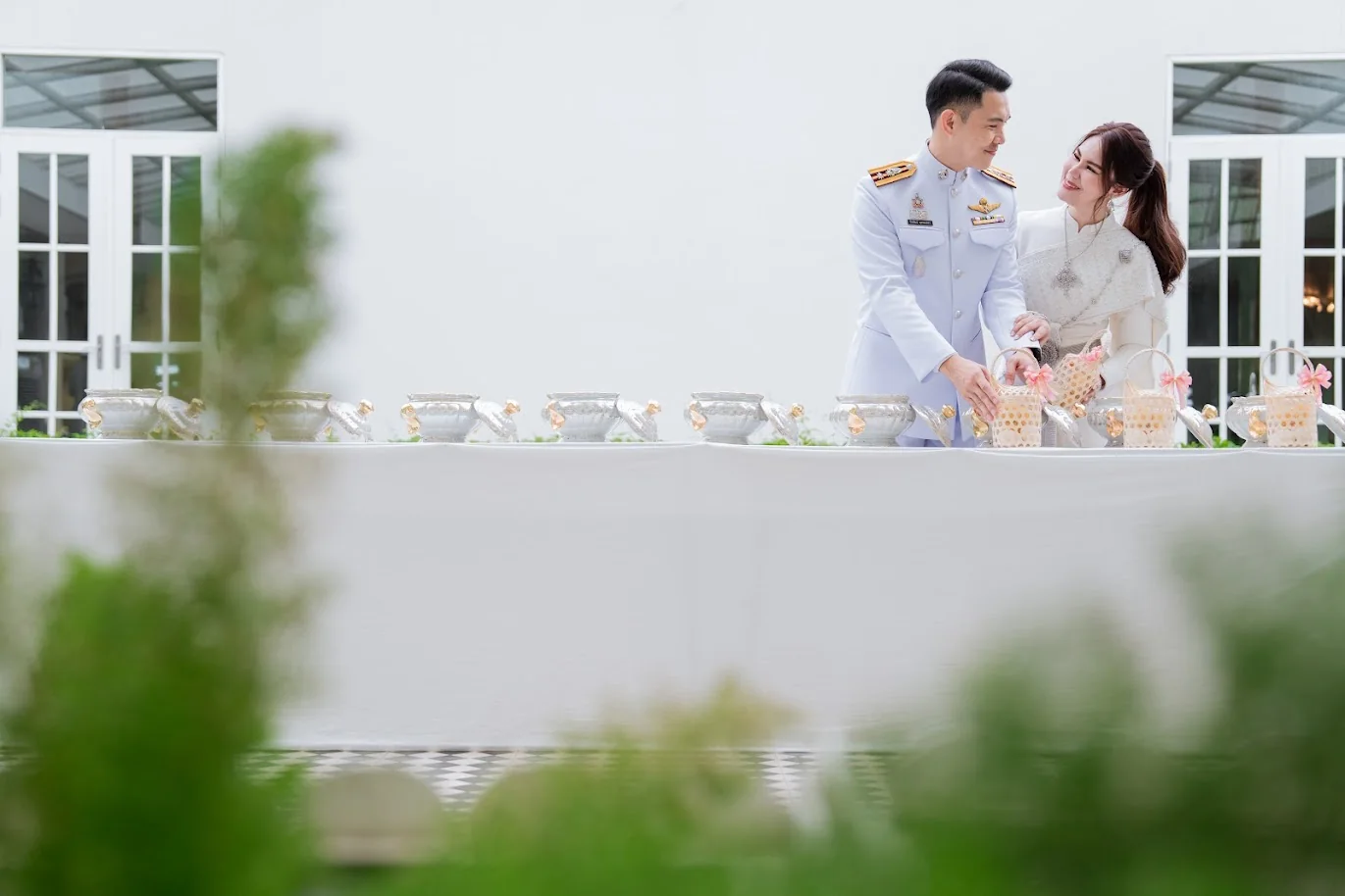 Couple at the outdoor water-pouring ceremony at the Koko & Raam celebration in Chonburi