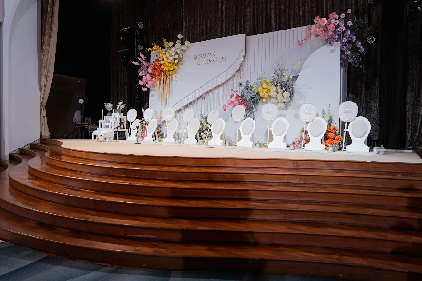 Indoor Thai ceremony table and floral stage at the Koko & Raam celebration in Chonburi
