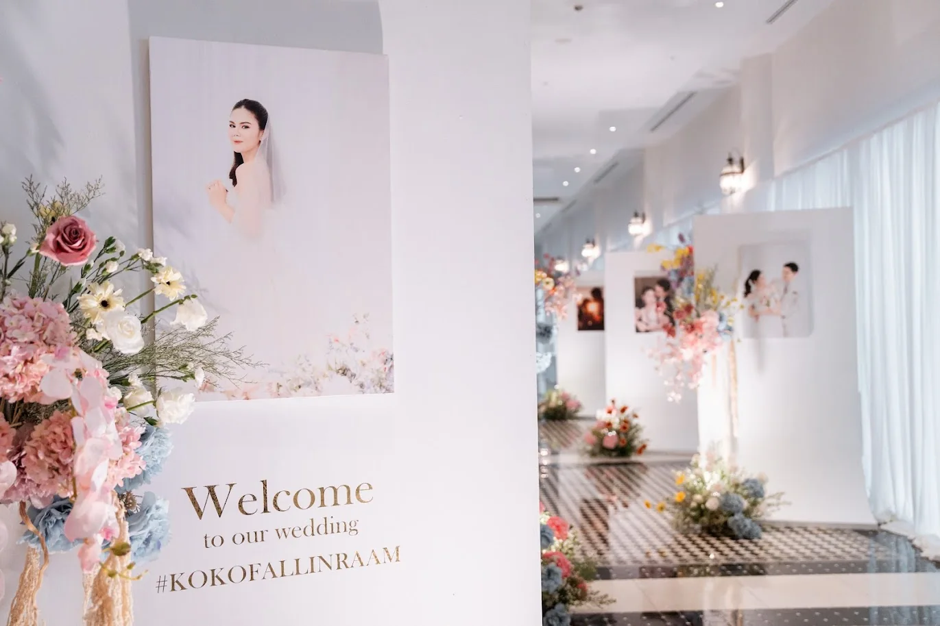 Pastel floral welcome photo display at the Koko & Raam celebration in Chonburi
