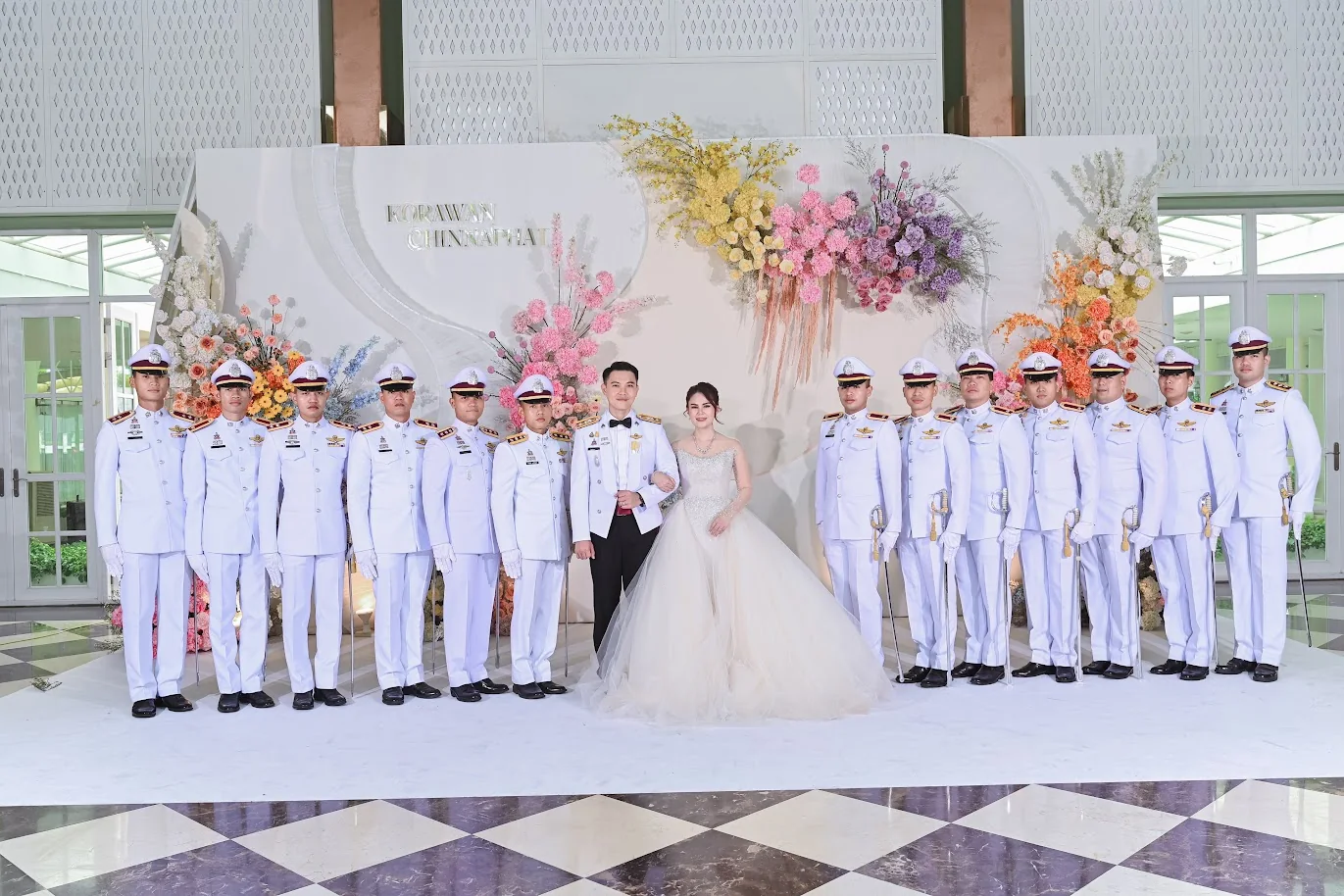 Couple with the military honour guard at the Koko & Raam celebration in Chonburi