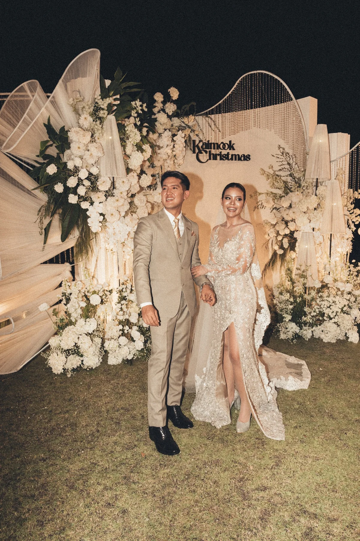 Couple portrait at the outdoor floral backdrop at the Mook — Christmas Wedding celebration in Lopburi