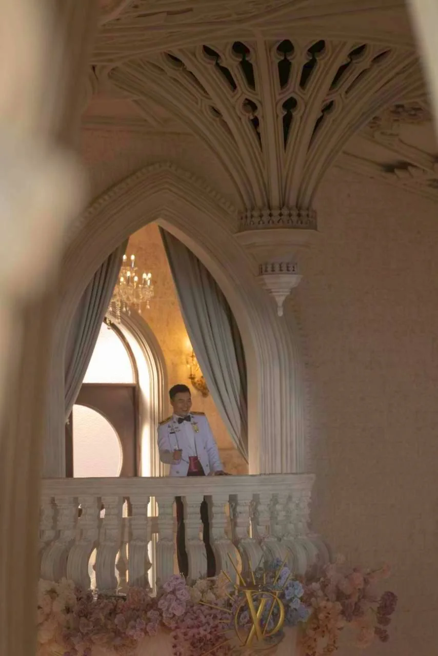 Bride standing on the chapel balcony at the Nan & Big celebration in Bangkok