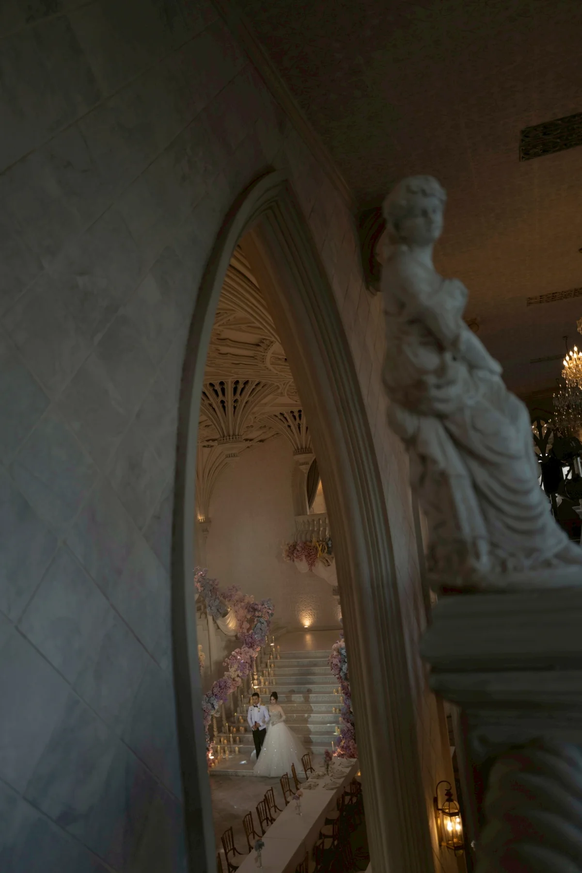 Bride silhouetted beside the chapel doorway at the Nan & Big celebration in Bangkok