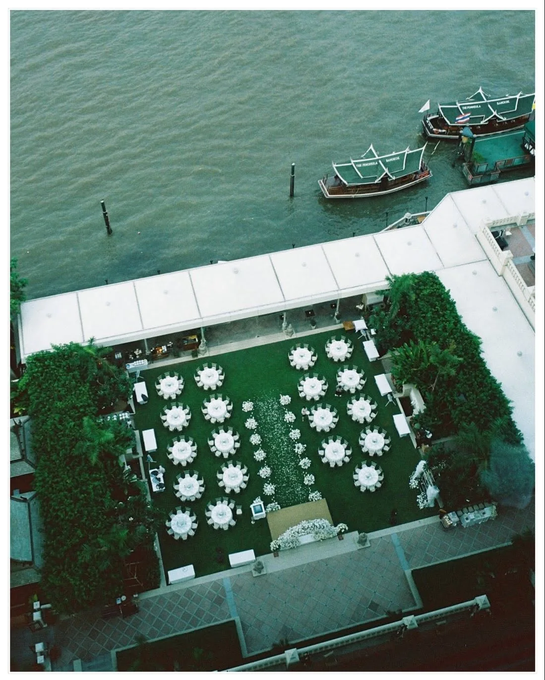 Aerial view of the riverside lawn ceremony at the Natt & Yang celebration in Bangkok