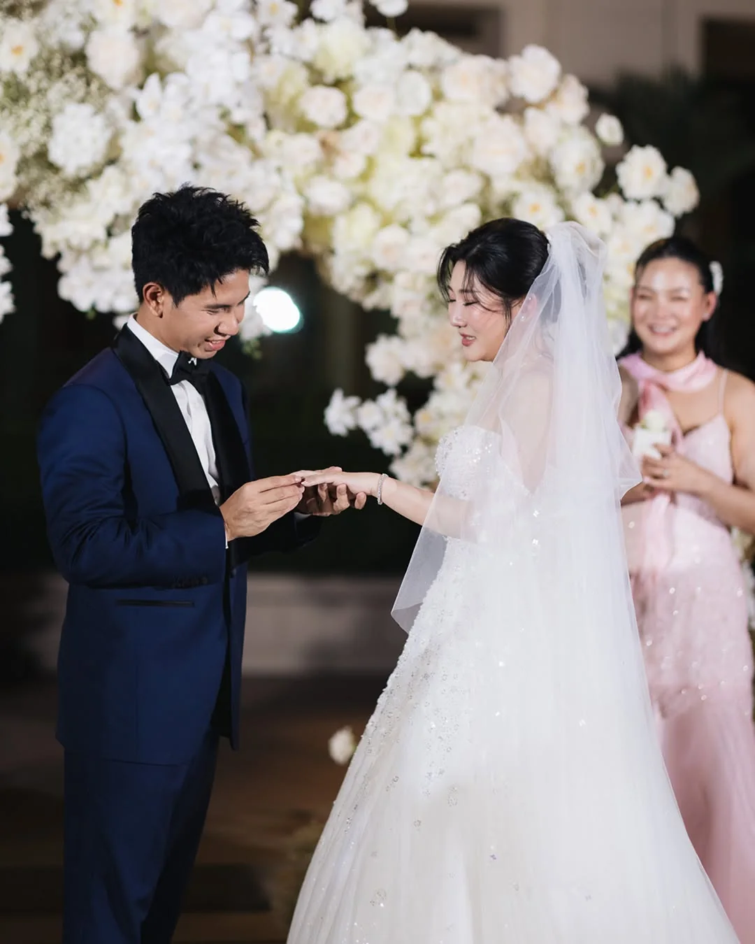 Couple exchanging rings during the ceremony at the Natt & Yang celebration in Bangkok