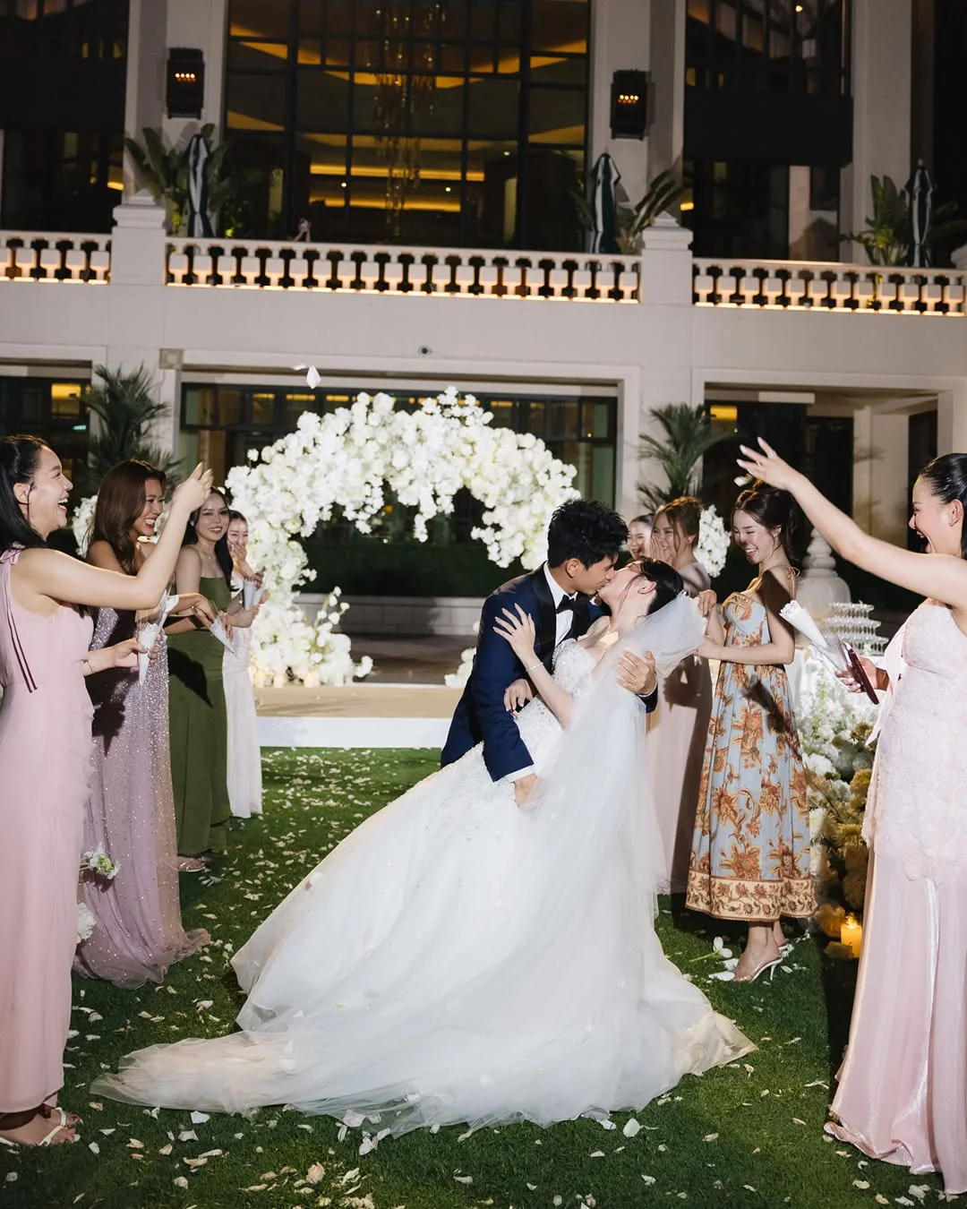 Couple walking through the guest aisle at the Natt & Yang celebration in Bangkok