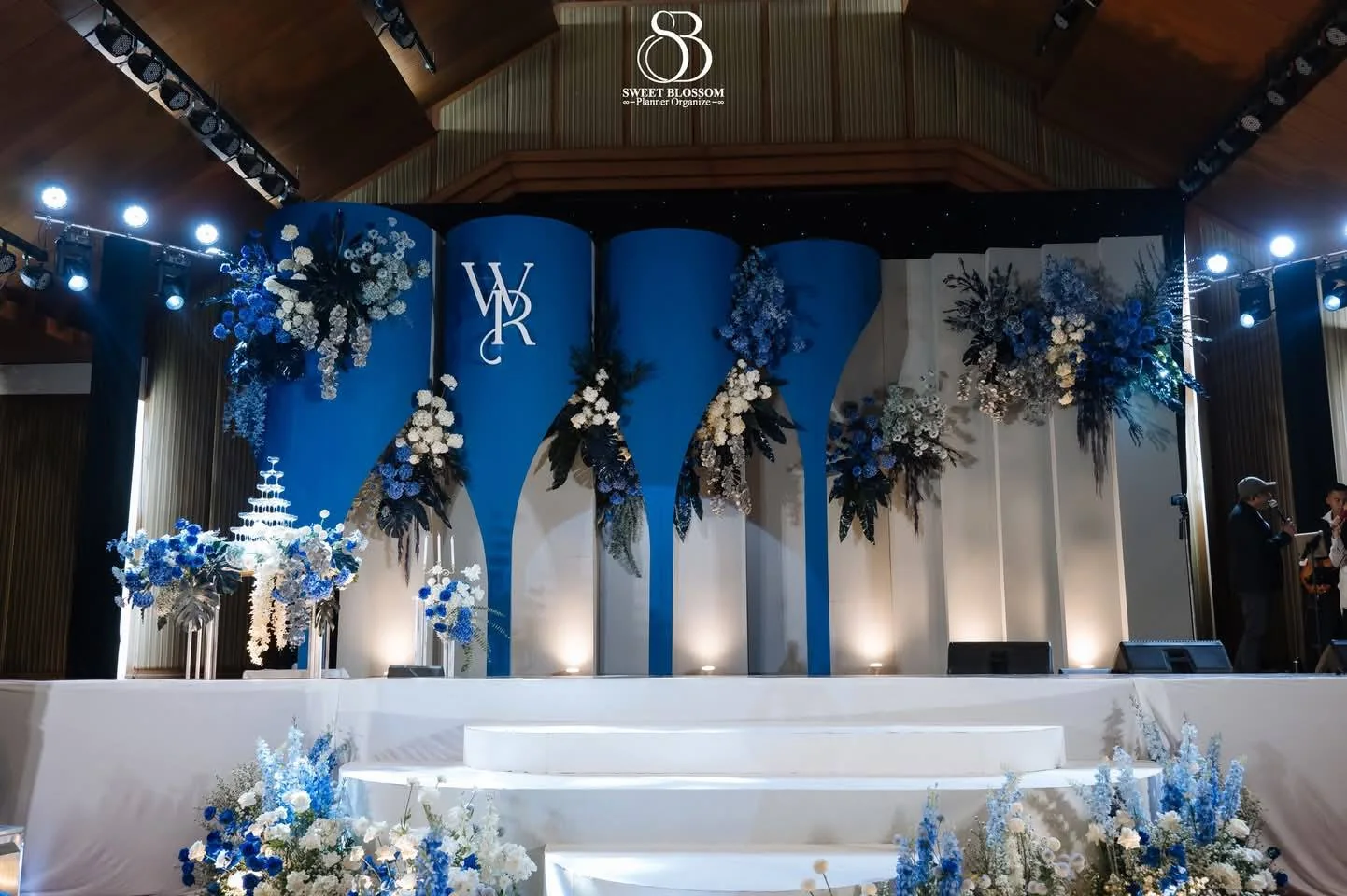 Wide view of the blue floral wedding stage at the Yam & Ball celebration in Lopburi